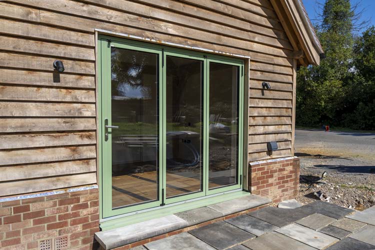 Dual colour aluminium bifold doors in a modern home