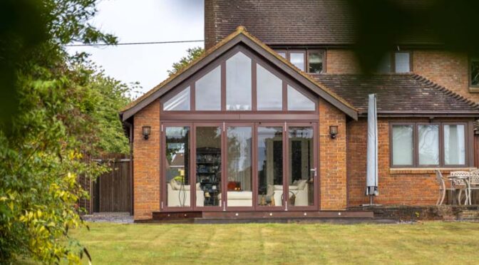 Composite gable end bifold doors with fixed glazed apex window