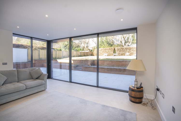 Large aluminium sliding patio doors with uninterrupted garden views