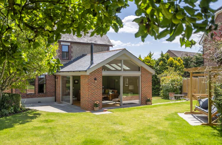 External sliding patio doors with large glazed panels and minimalist aluminium frames.