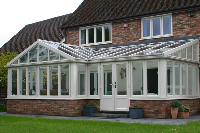 Gable conservatory with high vertical front and large windows for natural light