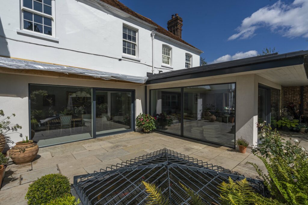 Contemporary open plan living room featuring external sliding patio doors.