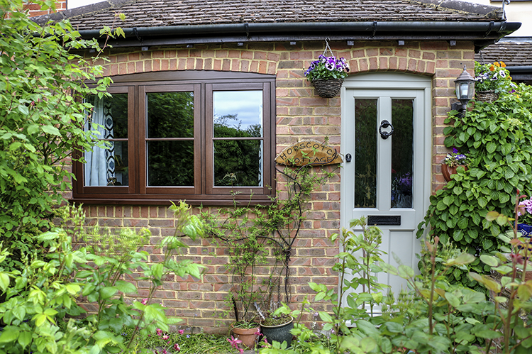 grey front door and brown windows