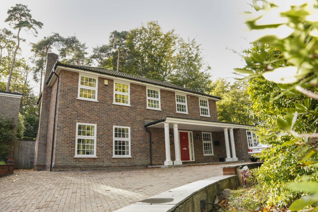 White bespoke uPVC sash windows on a traditional property