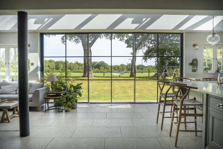 Open-plan kitchen with black aluminium bifold doors